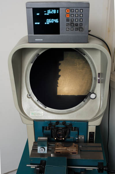 alt="The optical comparator displays highly magnified profile images for measurement or comparison with templates."